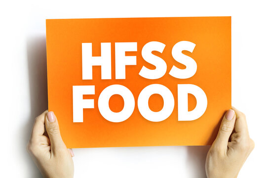 HFSS FOOD text on card held by hands, concept of unhealthy food high in fat, salt, and sugar in health and diet