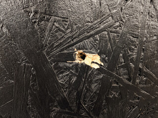 9mm Bullet Hole in Black Painted Oriented Strand Board Wood Panel Texture Detailed Close-up of Impact Damage in Construction Material
