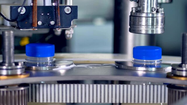 Automated Bottle Capping Machine on Industrial Production Line