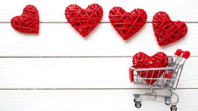 Red woven hearts on white wooden background for Valentine's Day
