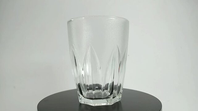 classic shaped glass, swirly and shiny, with white background