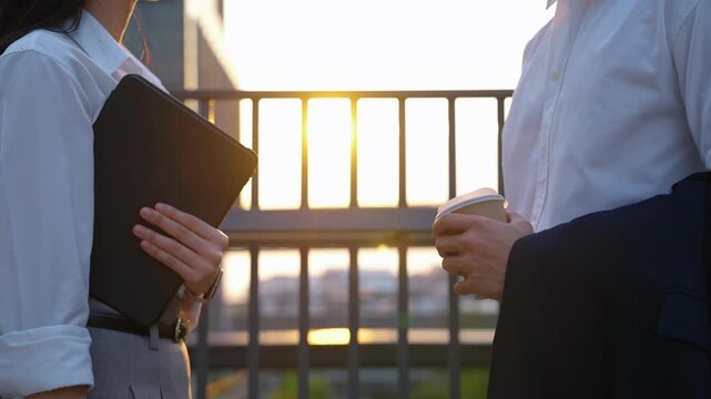 Business handshake at sunset symbolizing successful agreement and partnership in modern urban environment.