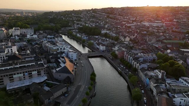 Evening glow over Cork city along the serene river Lee