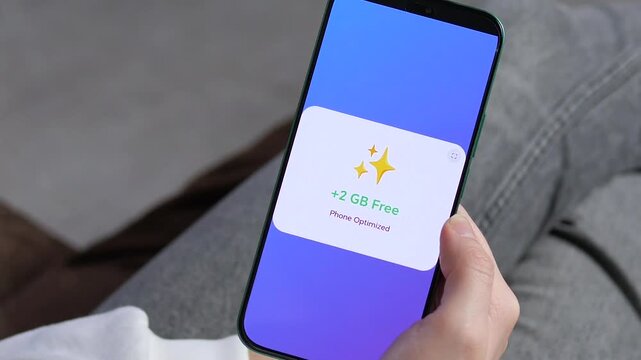 Fixing a slow phone with an optimization tool. Close-up of smartphone screen showing junk removal and storage cleaning process. Clear Phone Optimized success screen. Perfect for productivity tech and