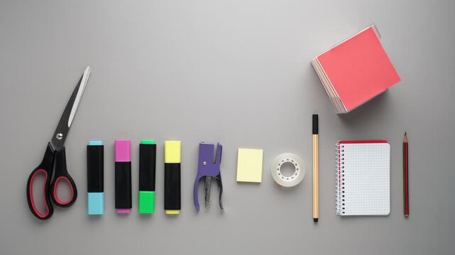 Stop Motion With Stationery Products on Gray Background Including Scissors and Markers
