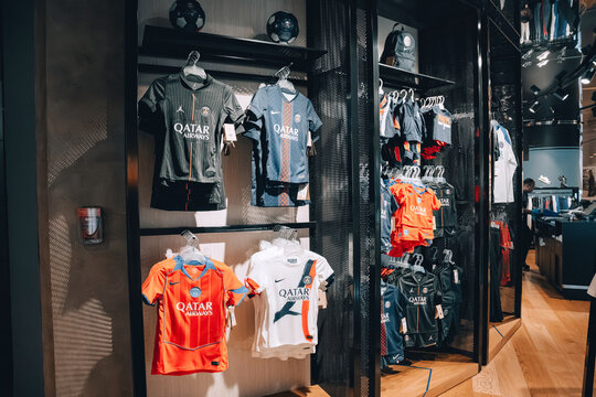 2 December 2025, Doha, Qatar: Paris Saint Germain football team kits and merchandise on display in a sports apparel shop