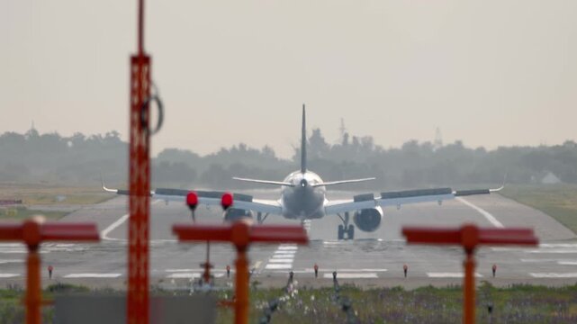 Footage of jet plane braking after landing, spoilers up. Airliner slowing down, rear view. Flight arriving