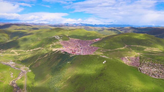 Aerial Mountain Valley Settlement with Green Hills