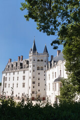 Fototapeta premium White French Chateau and Courtyard - Majestic white stone facade of the Château des Ducs de Bretagne in Nantes, France, featuring Gothic and Renaissance architectural details.