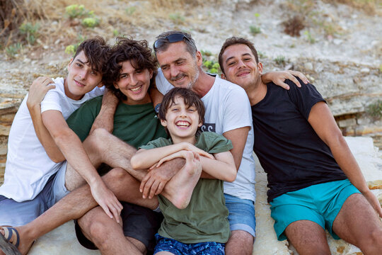Happy father spending time with his sons outdoors