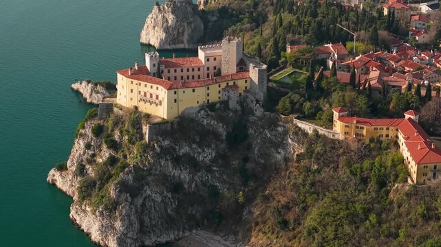 Castello di Duino Italy Aerial: Cinematic 70mm Zoom Lens Flight over Medieval Castle towards Observation Tower, Warm Sunset Light, Adriatic Sea Cliffs, Mediterranean Aesthetics Drone 4K Footage