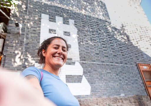 Woman smiling near chinese letter art in Chongqing