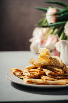 Stack of pancakes with butter and syrup
