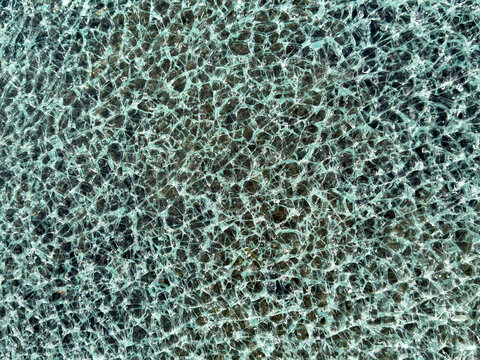 Close-up of shattered tempered glass texture background