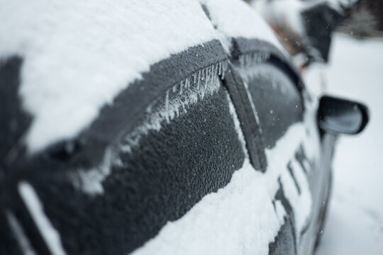 Car covered in snow and ice in winter weather