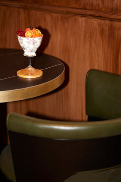Floral cocktail with fresh fruit garnish on table