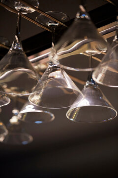 Hanging martini glasses in a dimly lit bar setting