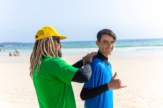 Surf coaching for autistic youth on the beach