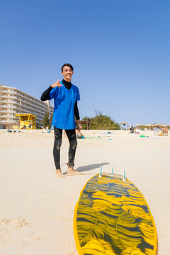 Autistic individual enjoying surfing on sunny beach