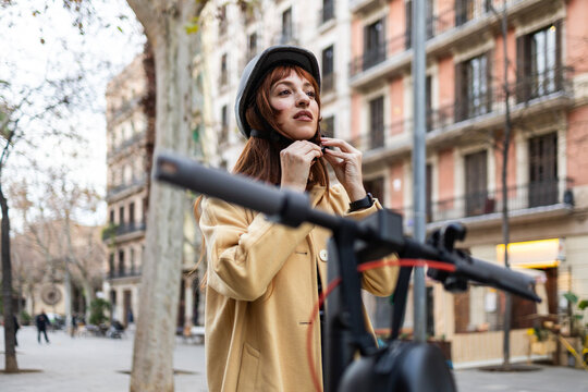 Woman preparing for urban scooter ride