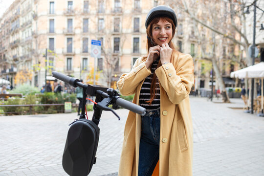 Woman with electric scooter in urban setting