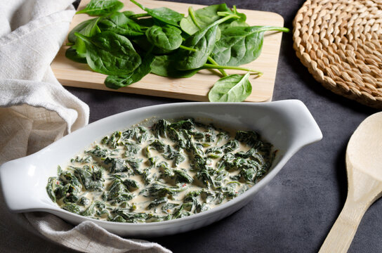 Delicious creamed spinach in a white serving dish