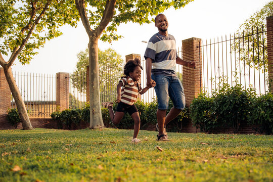 Father and daughter enjoying a sunny day in the park