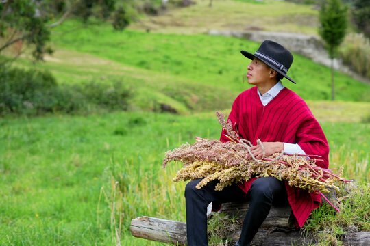 Indigenous man in traditional attire with harvest