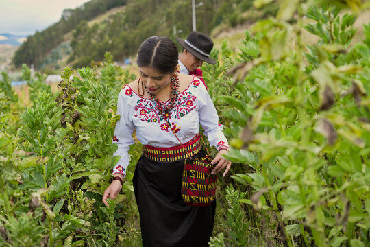 Puruwa couple in traditional attire amidst greenery