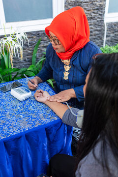 Nurse assisting patient in clinic setting