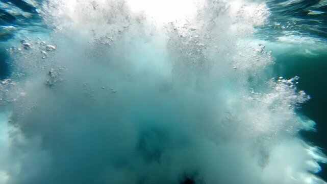 Underwater view of ocean waves rolling in at midday