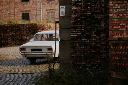 Vintage car parked in rustic brick setting
