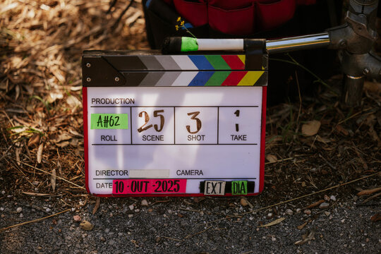 Film clapperboard on outdoor set in a natural setting