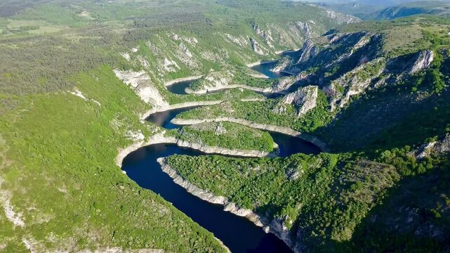 Aerial view of Uvac Canyon in Serbia. Aerial view of Uvac Canyon in Serbia showcases deep, winding meanders of the Uvac River cutting through rugged limestone cliffs. 