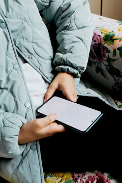 Person holding smartphone with blank screen