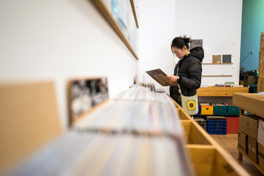 Browsing vinyl records in a cozy second-hand shop