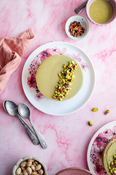 Pistachio and white chocolate cheesecake on floral plate