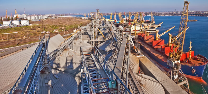 Industrial series of silver grain silos and port terminal logistics.