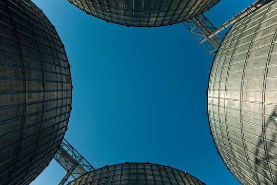 Industrial series of silver grain silos and port terminal logistics.
