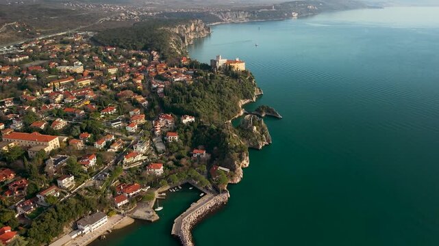 Duino Castle Italy Aerial Perspective: Flight Over Coastal Cliffs and Village Toward Medieval Fortress, Adriatic Sea Panorama, Cinematic Mediterranean Aesthetics Drone 4K  File1