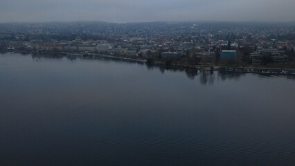 Fototapeta premium Aerial view of Zurich Lake and city skyline during a misty winter day, Switzerland.