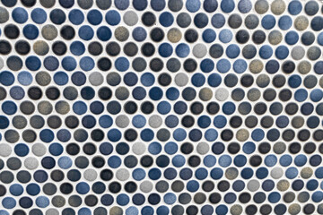 Pattern of small round mosaic tiles in blue and grey shades.