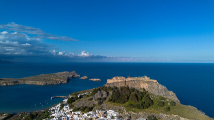 Fototapeta premium Rhodes, Greece. Lindos small whitewashed village and the Acropolis, scenery of Rhodos Island at Aegean Sea.