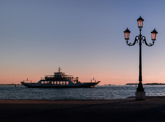 silhouette of boat  at the seaside next to a vintage lantern