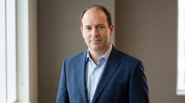 Confident Male Professional in Blue Suit Looking at Camera