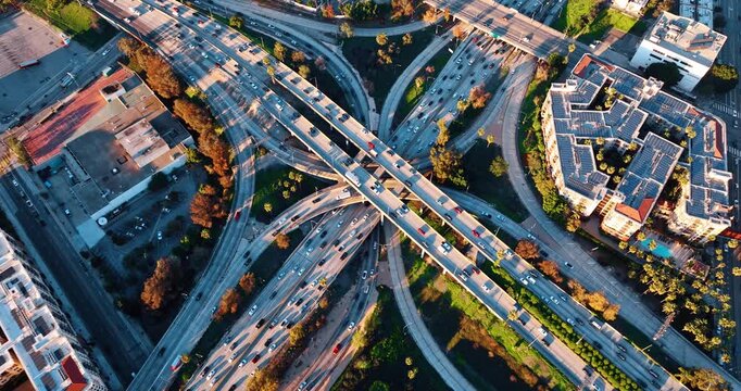 Stunning multi-level interchange with hectic traffic. Approaching modern intersection in Los Angeles downtown, California, US at sundown.