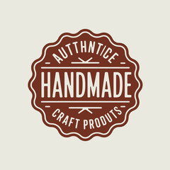 Authentic handmade craft products emblem on light background.