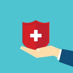 Obraz premium Hand holding shield with cross for the healthcare medical icon. Health insurance health concept. Access to welfare health and copy space