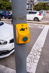 Pedestrian crossing push button on city street pole