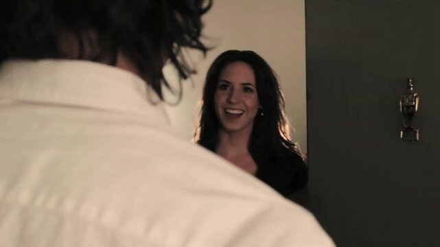 A man knocking on the 404 number door and surprises a Caucasian woman with bad news